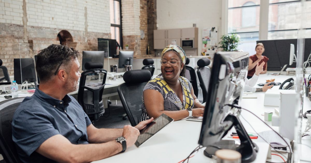 Middle aged man and woman talking in an office