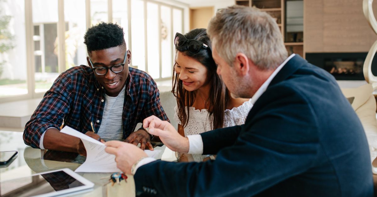 Three people looking at a paper document