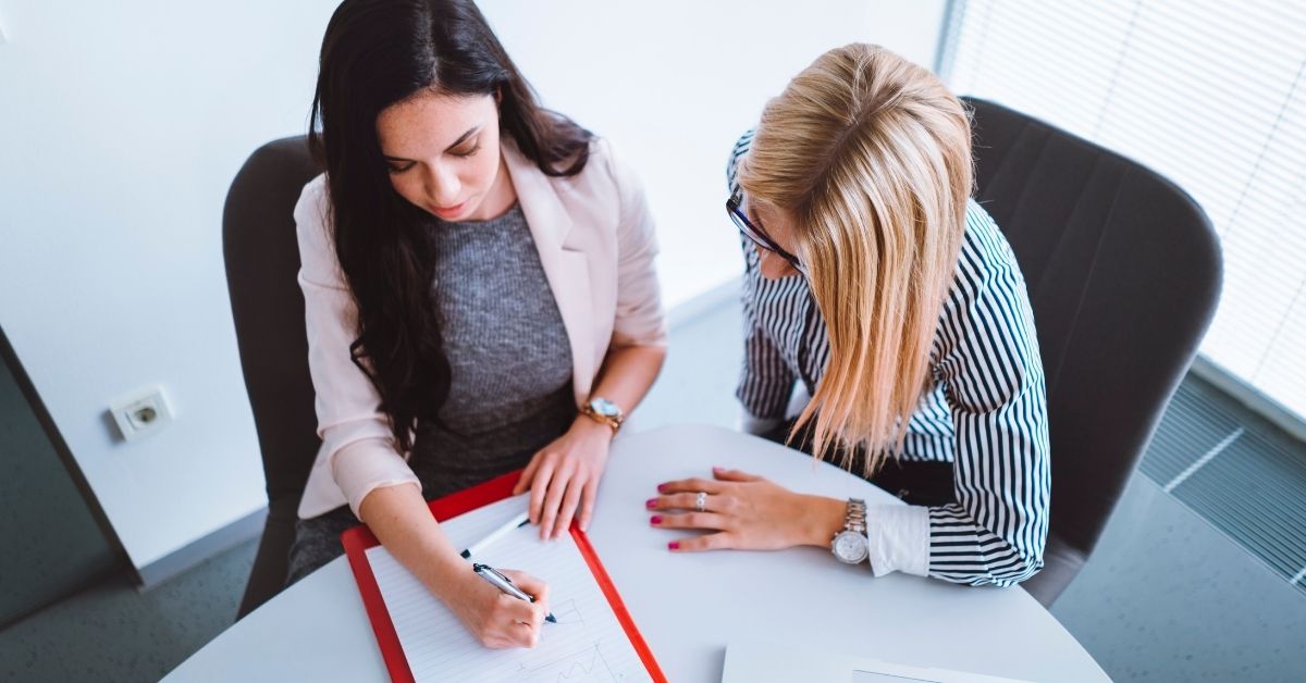 Two people reviewing a document