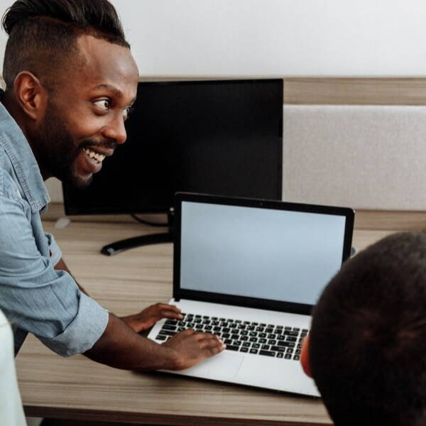 Smiling person using a laptop