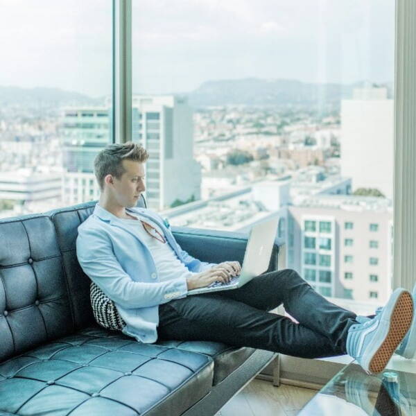 Person working on their couch with a city view behind them