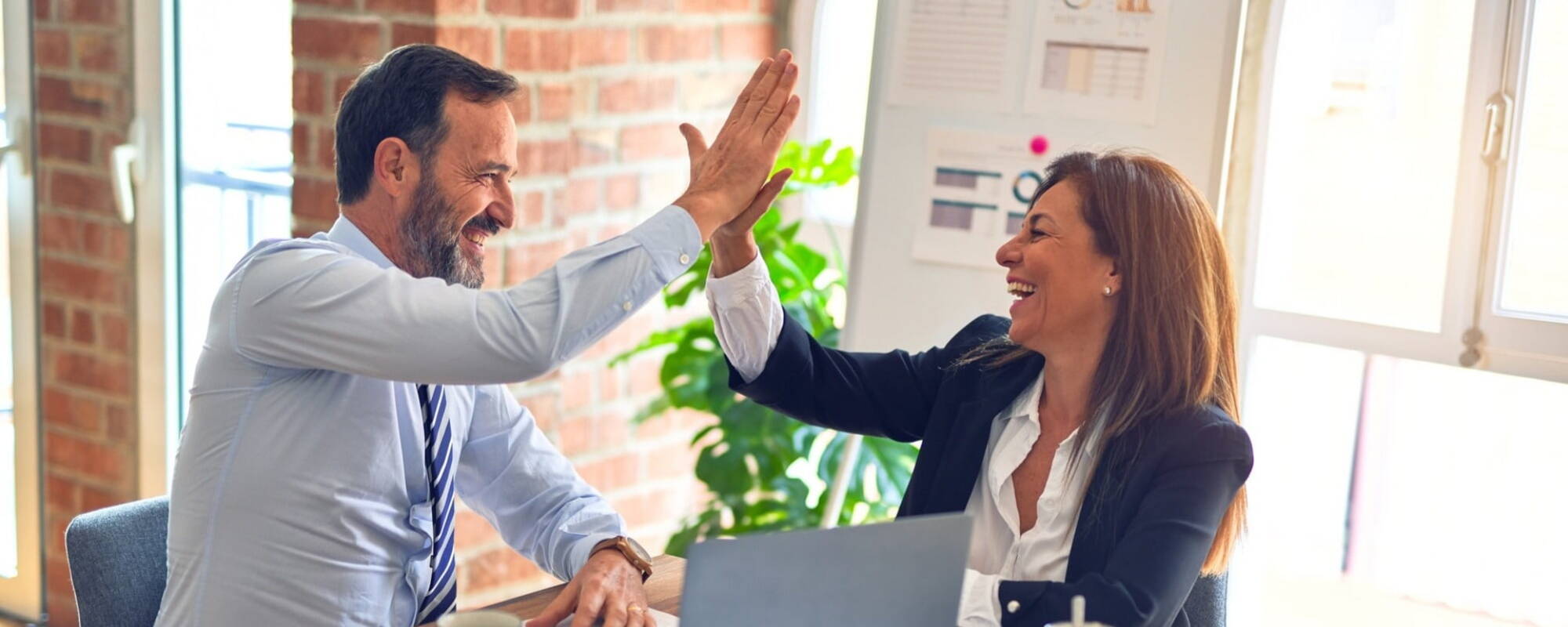 People high fiving in an office